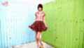 Ayana standing in back yard painted fences wearing brown dress in high heels