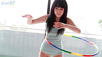 Machiko playing with a hula hoop wearing tight striped green vest long hair down over her breasts