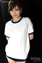 In gym class uniform hands behind her back